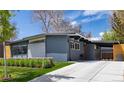 Charming single-story home with a gray exterior, well-manicured lawn, and a paved driveway at 1321 S Edison Way, Denver, CO 80222