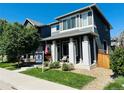 Beautiful two-story home featuring a covered front porch, well-maintained lawn, and a 'For Sale' sign at 6834 Clay N St, Denver, CO 80221