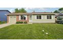 Charming single-story home featuring a well-manicured lawn, brick accents, and a convenient attached garage at 4759 S Xenophon St, Morrison, CO 80465