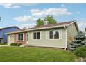 Charming single-story home featuring a well-manicured lawn, brick accents, and white-trimmed windows at 4759 S Xenophon St, Morrison, CO 80465