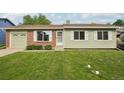 Charming single-story home featuring a well-manicured lawn, brick accents, and a convenient attached garage at 4759 S Xenophon St, Morrison, CO 80465