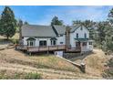 A spacious deck extends from the house, offering a place to relax and enjoy the outdoors at 9310 S Watson Gulch Rd, Littleton, CO 80127