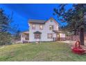 Charming home with a well-manicured lawn, bay window, and inviting front porch at 9310 S Watson Gulch Rd, Littleton, CO 80127