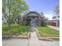 Quaint single story home featuring a lush green lawn at 833 Osceola St, Denver, CO 80204