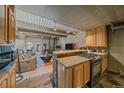 Cozy living room features a spiral staircase, comfortable seating, and open layout into the kitchen at 80 Clear Creek Ln # 10, Golden, CO 80403