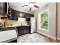 Efficient kitchen with stainless steel appliances, dark cabinetry, and ample counter space for meal preparation at 1331 Osceola St, Denver, CO 80204