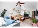 Bright living room with hardwood floors, a ceiling fan, and access to the dining area, creating a comfortable space at 1331 Osceola St, Denver, CO 80204