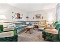 Cozy living room featuring vintage furnishings, a plush sofa, and an inviting, classic design at 2516 S Cimarron St, Aurora, CO 80014