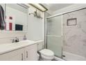 Modern bathroom featuring marble tile shower with glass door, and sleek vanity sink at 6366 Nassau Ct, Highlands Ranch, CO 80130