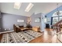 Bright living room with vaulted ceilings, skylights, hardwood floors and modern decor at 6366 Nassau Ct, Highlands Ranch, CO 80130