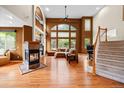 Spacious living room boasts high ceilings, large windows, a cozy fireplace, and gleaming hardwood floors at 6427 S Tibet St, Aurora, CO 80016