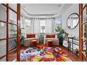 Bright sitting room with beautiful hardwood floors, plenty of light, and tastefully decorated interior at 6427 S Tibet St, Aurora, CO 80016