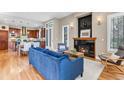 Cozy living room featuring a modern fireplace, comfortable seating, and seamless kitchen access at 920 Neon Forest Cir, Longmont, CO 80504