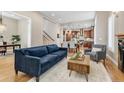 Spacious living room featuring hardwood floors, contemporary furniture, and an open-concept design at 920 Neon Forest Cir, Longmont, CO 80504