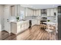Modern kitchen with sleek countertops, stainless steel appliances, and custom cabinets with eat-in table at 4385 Carr St, Wheat Ridge, CO 80033