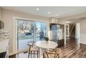 Kitchen with stainless steel refrigerator and sliding doors to backyard with hot tub and seating at 4385 Carr St, Wheat Ridge, CO 80033