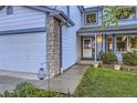 Inviting entrance showcases stone details, a charming front door, and well-manicured landscaping at 5455 W 112Th Pl, Westminster, CO 80020