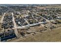 Aerial view shows new development site and nearby Main Street with existing homes and future parking lot location at 653 S Main St, Elizabeth, CO 80107