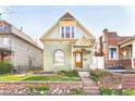 Beautiful exterior view of a quaint home with inviting front porch, landscaped yard, and classic architectural design at 3337 Decatur St, Denver, CO 80211