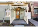 Cozy front porch with intricate railing and design, inviting you to relax and enjoy the outdoor space of this charming home at 3337 Decatur St, Denver, CO 80211