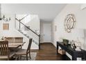 Warm entryway with hardwood floors, staircase, table, neutral walls, and stylish decor setting a welcoming tone at 7678 S Old Hammer Way, Aurora, CO 80016