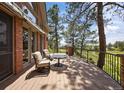 Spacious deck with outdoor seating, perfect for enjoying the tranquil scenery and golf course views at 120 Silver Leaf Way, Castle Rock, CO 80108