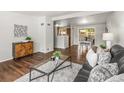 Open concept living space with hardwood floors, plush rug, and dining area view at 5995 Estes St, Arvada, CO 80004
