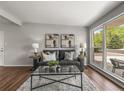 Bright living room featuring a comfortable sofa, stylish decor, and large windows at 5995 Estes St, Arvada, CO 80004