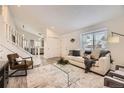 Inviting living room showcasing stairs, sleek furnishings, and ample natural light at 6102 S Owens Ct, Littleton, CO 80127