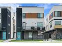 Modern townhouse exterior featuring brick accents, grilling balcony, and a vibrant blue front door at 1930 Hooker St # 3, Denver, CO 80204
