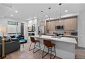 Bright and open floor plan with modern kitchen, living room, and fireplace at 1930 Hooker St # 3, Denver, CO 80204