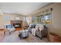 Inviting living room with stone fireplace, natural light, and comfortable seating at 3540 Vrain St, Denver, CO 80212