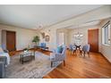 Spacious living room featuring hardwood floors, stylish furniture, and open dining area at 3540 Vrain St, Denver, CO 80212