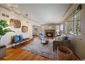 Cozy living room with a fireplace, hardwood floors, and neutral decor at 3540 Vrain St, Denver, CO 80212