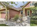 Charming home featuring an inviting front porch and stone accents around the entryway at 1562 Suncrest Rd, Castle Rock, CO 80104