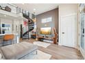 Open-concept living space with modern furniture, spiral staircase, and stylish accents at 3550 W 63Rd Ave, Denver, CO 80221