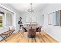 Beautiful dining room with modern light fixture, round table, and stylish decor at 2484 E 101St Ct, Thornton, CO 80229