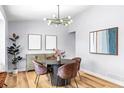 Beautiful dining room with modern light fixture, round table, and stylish decor at 2484 E 101St Ct, Thornton, CO 80229