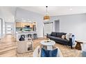 Inviting living room with open layout, seamlessly connected to the modern kitchen and offering ample seating at 2484 E 101St Ct, Thornton, CO 80229