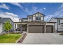 Attractive two-story home with a stone-accented front, three-car garage, and landscaped lawn at 5392 Sanctuary Ave, Firestone, CO 80504