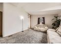 Cozy living room with neutral carpet, natural light, and comfortable seating area at 664 Stampede Dr, Brighton, CO 80603