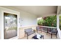 Inviting front porch with seating area to enjoy outdoors at 2160 Ance St, Strasburg, CO 80136