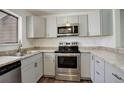 Modern kitchen featuring stainless steel appliances and light gray cabinetry at 9105 Oberon Rd # 2, Arvada, CO 80004