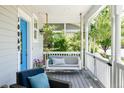Relaxing front porch featuring a comfortable swing and stylish seating area, perfect for unwinding outdoors at 10069 E 28Th Ave, Denver, CO 80238