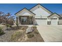 Charming two-story home featuring a three-car garage, stone accents, and a well-maintained front yard at 21701 E 50Th Dr, Aurora, CO 80019