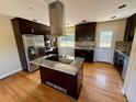 Kitchen featuring granite counters, modern appliances, and hardwood floors at 8127 Lafayette St, Denver, CO 80229