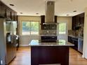 Kitchen featuring granite counters, stainless steel appliances, and hardwood floors at 8127 Lafayette St, Denver, CO 80229