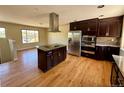 Open kitchen with a granite island, stainless steel appliances and lots of cabinet space at 8127 Lafayette St, Denver, CO 80229