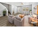 Virtually staged living room with light gray walls and wood-look floors at 4758 Kittredge St # 2, Denver, CO 80239