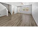 Open living room with wood-look floors and neutral color palette at 4758 Kittredge St # 2, Denver, CO 80239